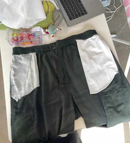 Adding New Pocket to Trousers Folded black trousers inside out on a table, with new pockets added